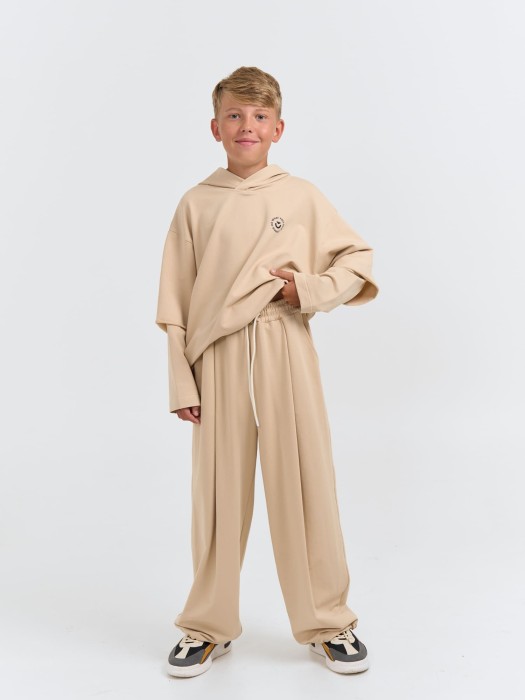 джоггеры оверсайз облегченные "крем-брюле" с карманами 7+ от бренда bungly вид слева