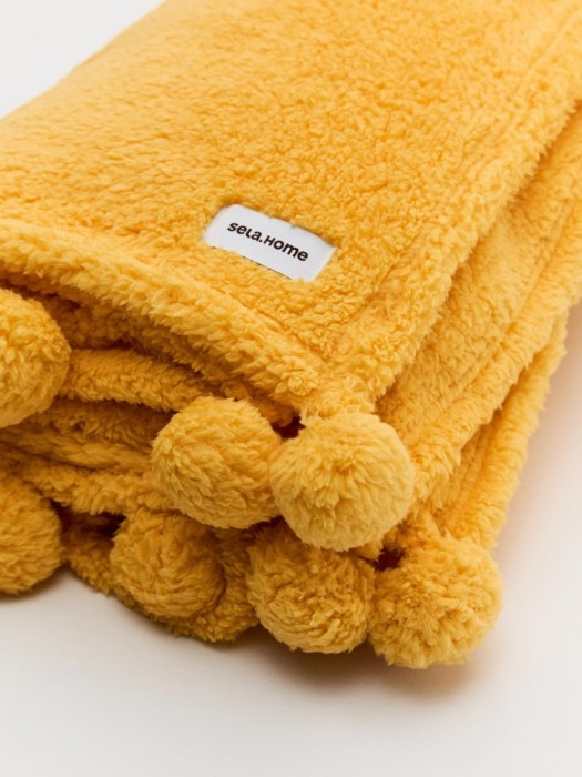 флисовый плед с помпонами детский от бренда sela вид слева