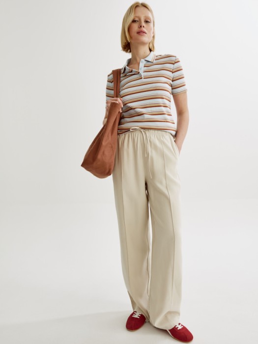 поло приталенное в полоску от бренда sela вид слева