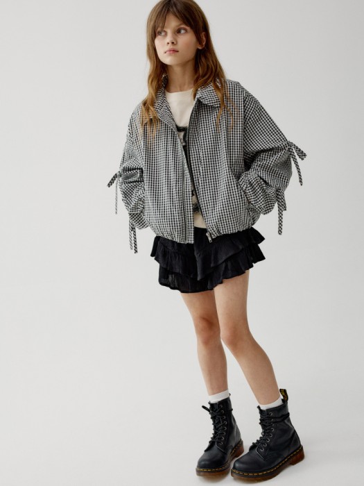 ветровка в клетку с бантиками для девочек от бренда sela вид слева