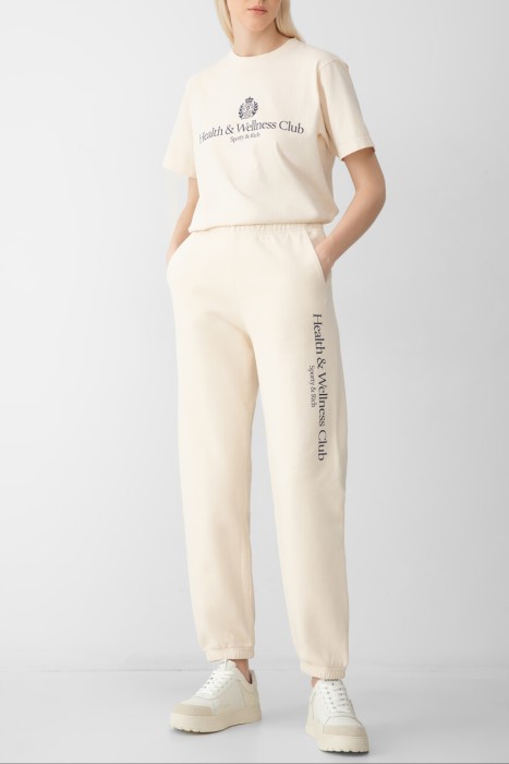 брюки sporty rich модель h&w crest из хлопка спереди