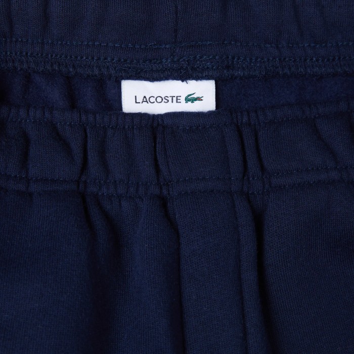 детские спортивные брюки  от бренда lacoste вид слева