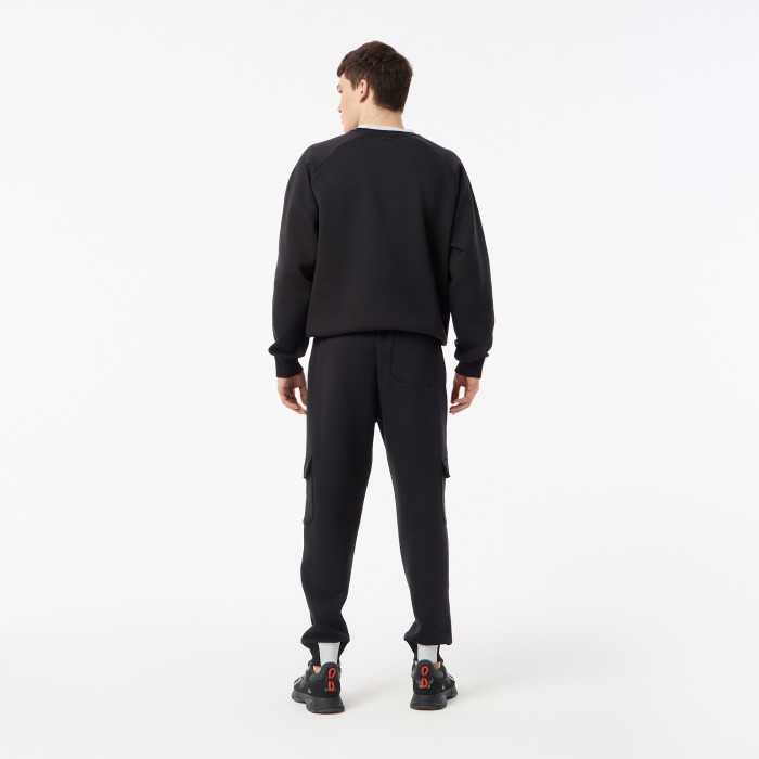 мужские спортивные брюки  из эластичного хлопка от бренда lacoste вид слева