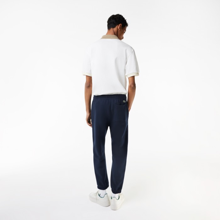 мужские спортивные брюки  свободного кроя из хлопка от бренда lacoste вид слева