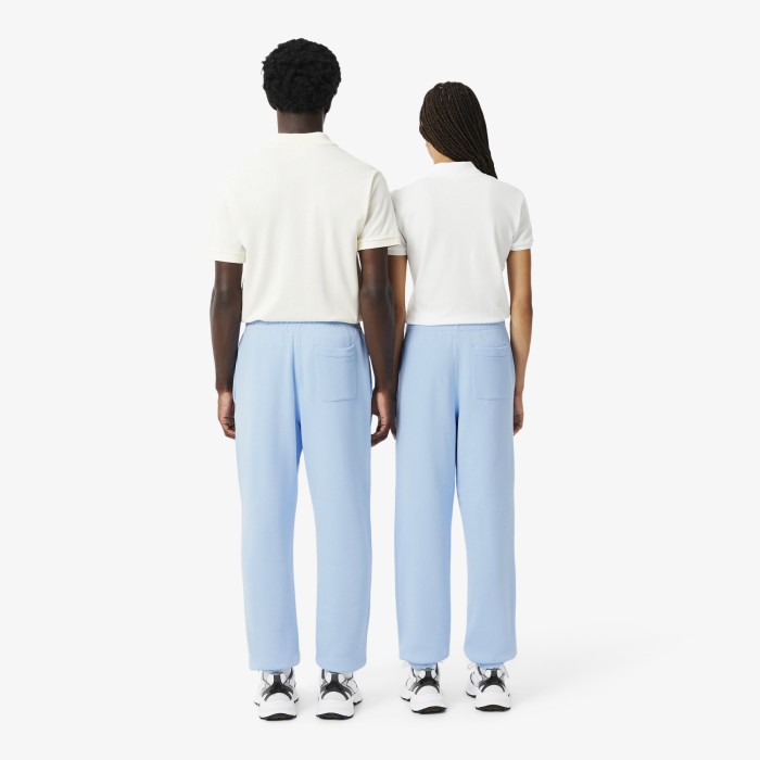 спортивные хлопковые брюки  унисекс свободного кроя от бренда lacoste вид слева