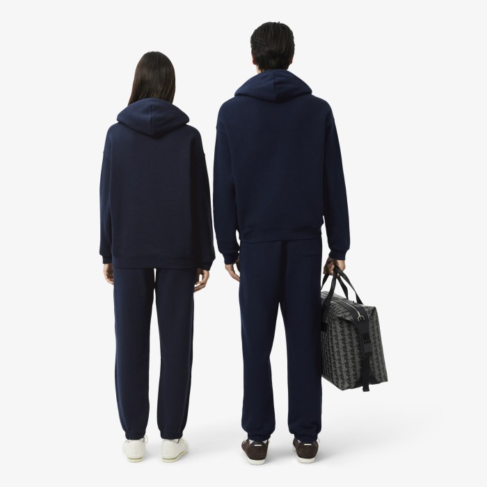 спортивные хлопковые брюки  унисекс свободного кроя от бренда lacoste вид слева
