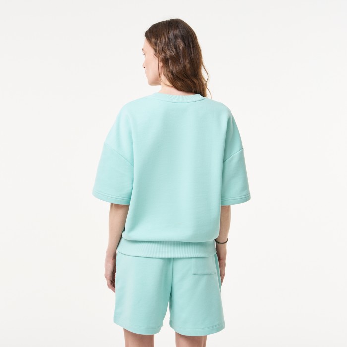 женская толстовка  свободного кроя с коротким рукавом от бренда lacoste вид слева
