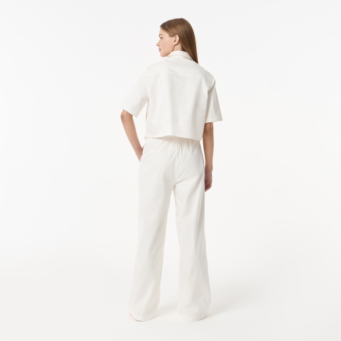женские брюки  из эластичного хлопка от бренда lacoste вид слева
