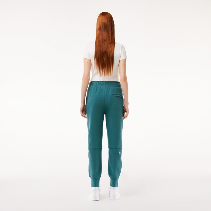 женские спортивные брюки  из хлопка от бренда lacoste вид слева