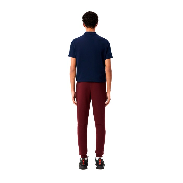 спортивные штаны slim fit от бренда lacoste вид слева